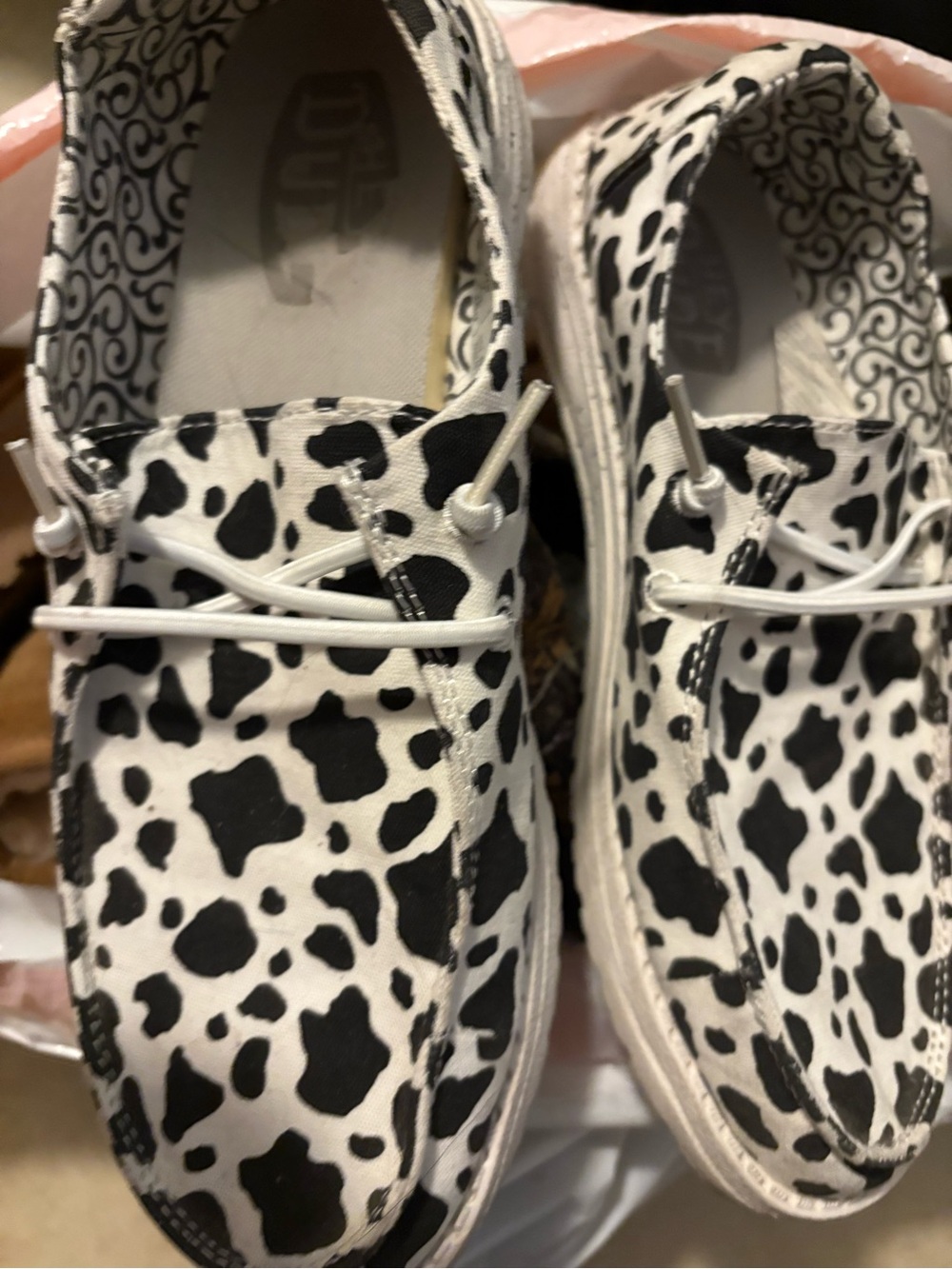 Hey Dude Black and White Cow Print Slip-On Sneakers